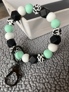 Teal and cow wristlet