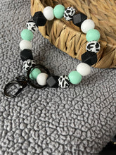Load image into Gallery viewer, Teal and cow wristlet
