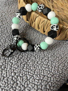 Teal and cow wristlet